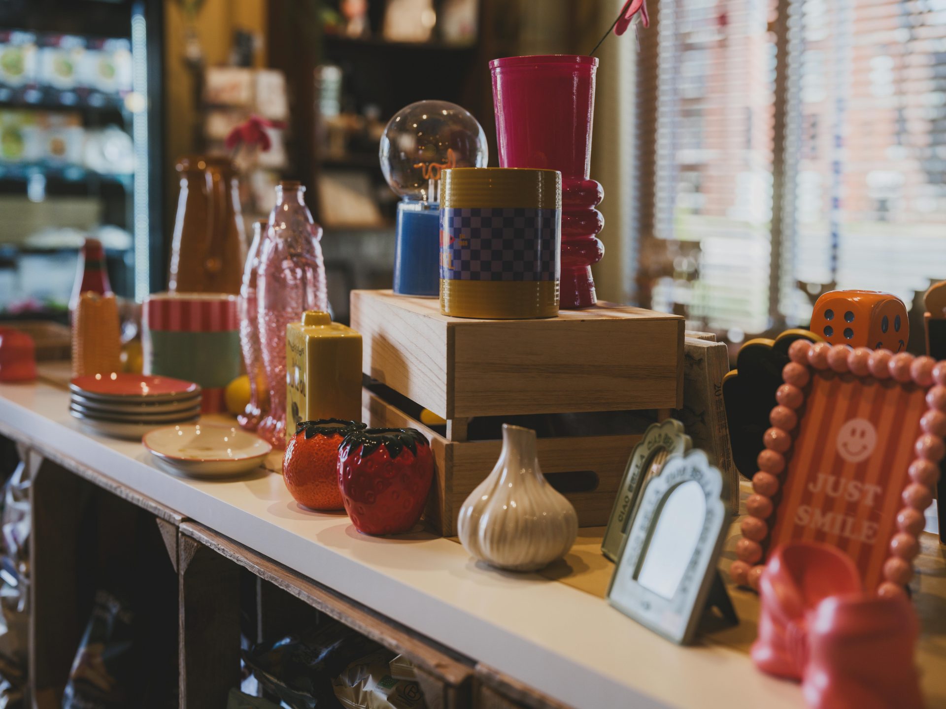 Vibrant gift shop display featuring artistic decor items and colorful ceramics.